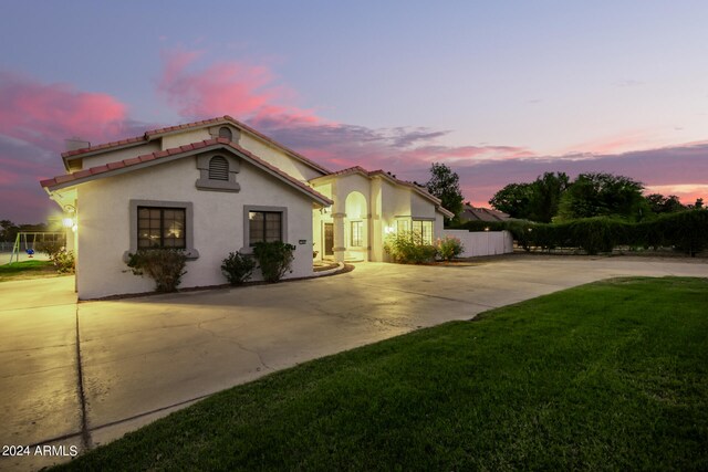 mediterranean / spanish-style house with a lawn