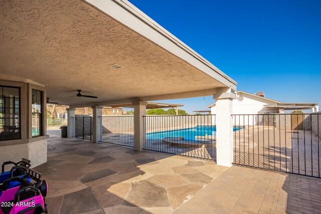 view of patio featuring ceiling fan and a fenced in pool