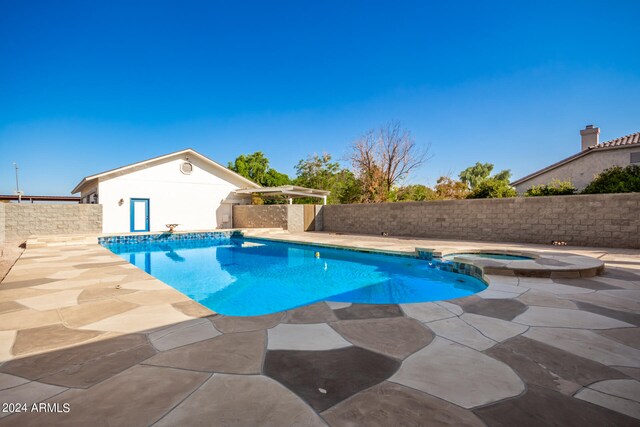 view of pool with an in ground hot tub and a patio