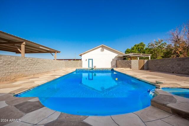 view of swimming pool with an in ground hot tub and a patio