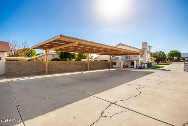 view of vehicle parking with a carport