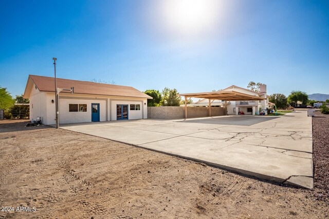 back of property with a carport