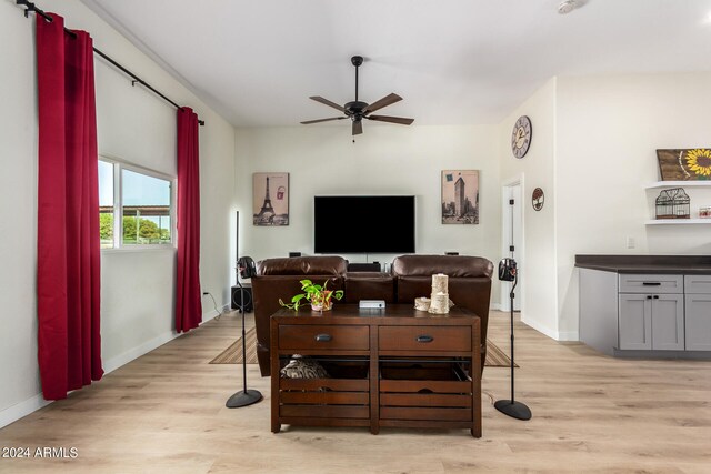 living room featuring light hardwood / wood-style flooring and ceiling fan