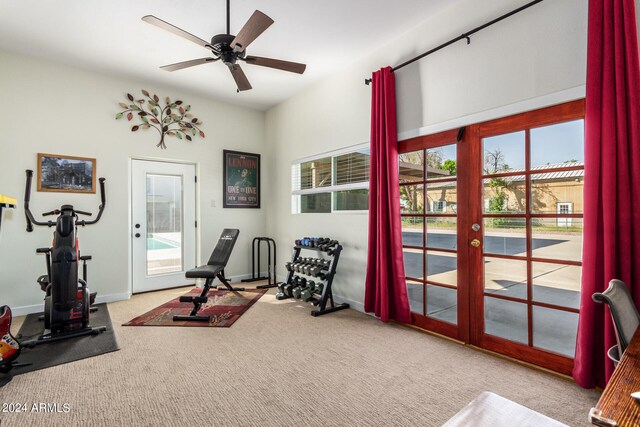 exercise room featuring light carpet, ceiling fan, and french doors