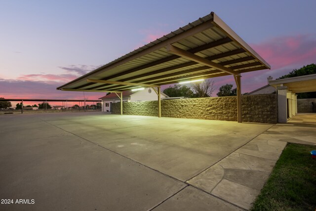 patio terrace at dusk featuring a carport