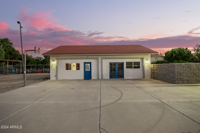 view of garage at dusk