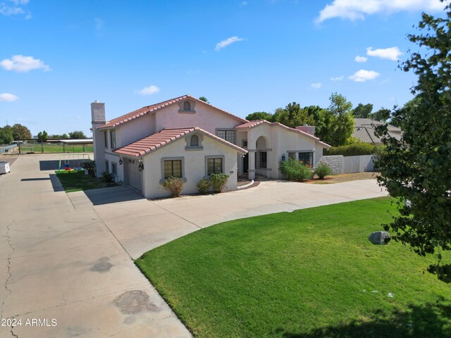 mediterranean / spanish-style home featuring a front lawn