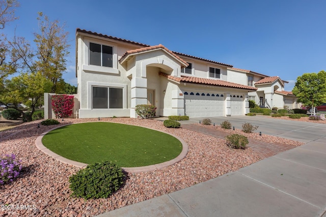 mediterranean / spanish-style house with driveway, a tile roof, a garage, and stucco siding