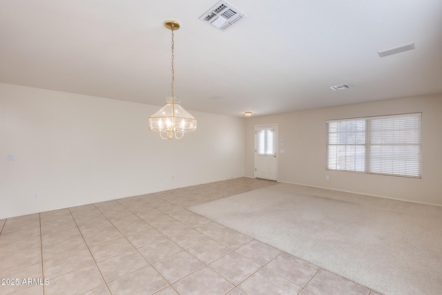 unfurnished room with a notable chandelier, light tile patterned floors, visible vents, and light colored carpet