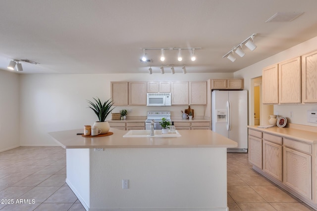 kitchen with white appliances, light tile patterned flooring, light countertops, and light brown cabinetry