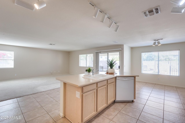 kitchen with visible vents, open floor plan, white dishwasher, light brown cabinets, and a sink