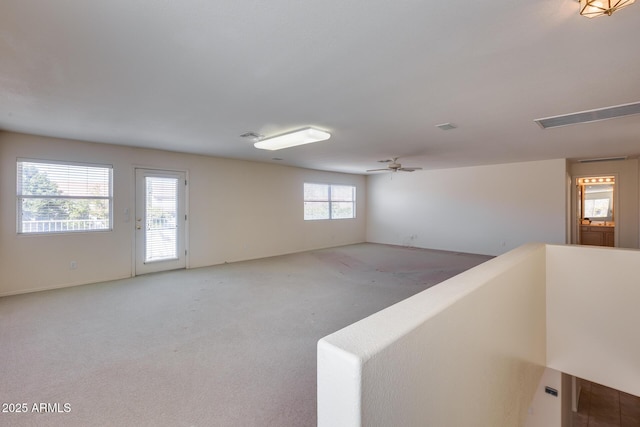 carpeted spare room featuring ceiling fan