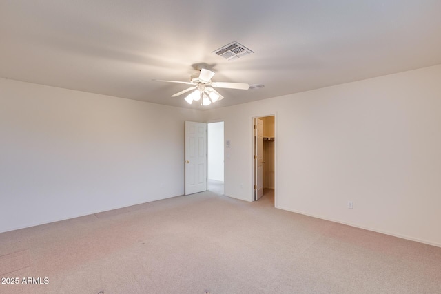 unfurnished room featuring a ceiling fan, light colored carpet, and visible vents