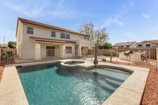 view of pool featuring a patio area, a fenced backyard, and a pool with connected hot tub