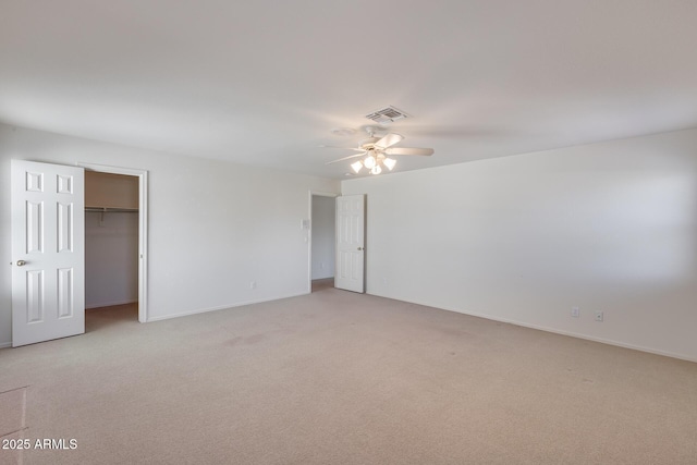 unfurnished bedroom featuring light carpet, baseboards, visible vents, and a ceiling fan