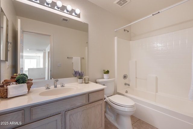 bathroom with toilet, vanity, visible vents, and tile patterned floors