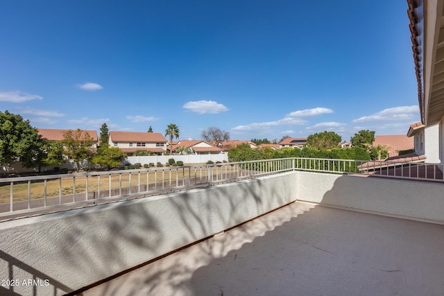 view of patio featuring a balcony and a residential view