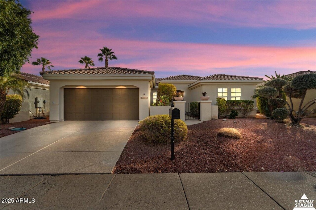 mediterranean / spanish home featuring a garage