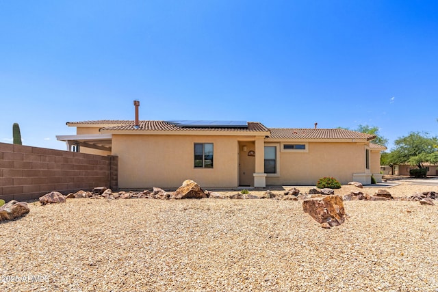 view of front of property featuring solar panels