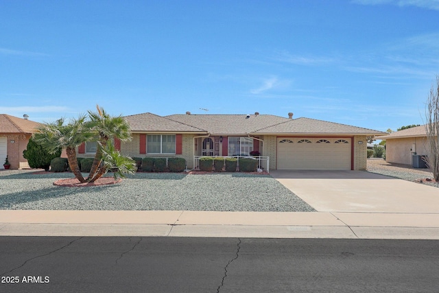 ranch-style home featuring a garage and central AC