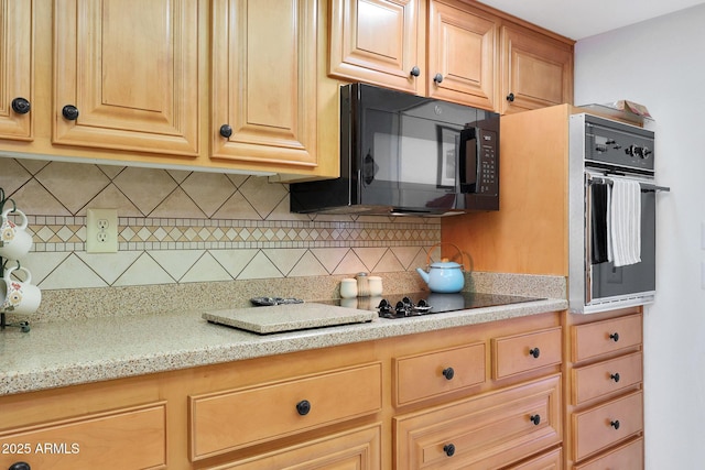 kitchen featuring tasteful backsplash, light stone counters, wall oven, and light brown cabinets