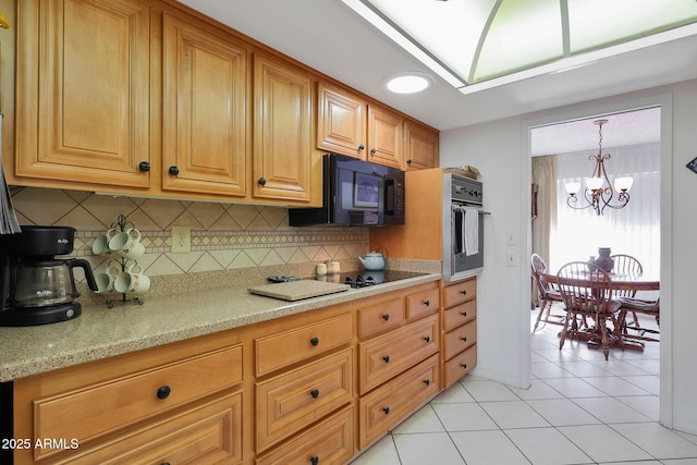 kitchen featuring light tile patterned flooring, light stone countertops, oven, and backsplash