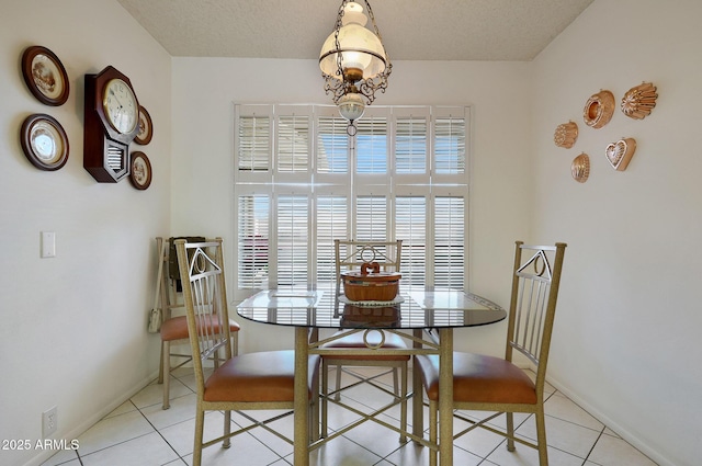 dining room with light tile patterned floors and a textured ceiling