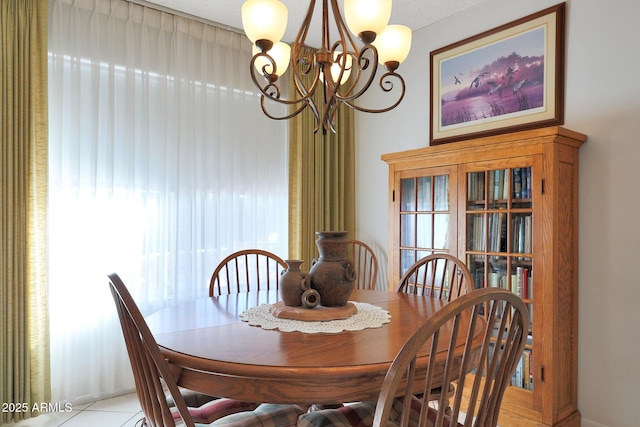 tiled dining room featuring an inviting chandelier