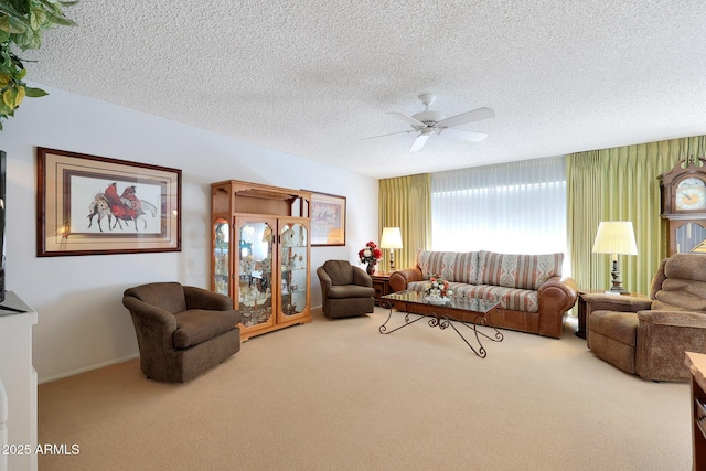 carpeted living room featuring a textured ceiling and ceiling fan