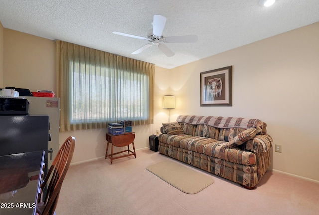 living room with ceiling fan, a textured ceiling, and carpet flooring