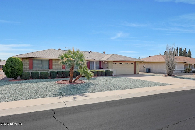 ranch-style home featuring cooling unit and a garage