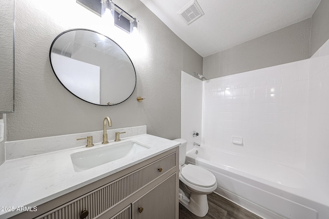 2025 E Campbell Ave Unit 137, Phoenix, AZ 85016 - bathroom with a textured wall, wood finished floors, vanity, and washtub / shower combination
