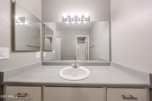 2025 E Campbell Ave Unit 137, Phoenix, AZ 85016 - bathroom featuring a textured wall and vanity