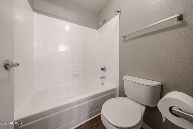 2025 E Campbell Ave Unit 137, Phoenix, AZ 85016 - bathroom with shower / bath combination, a textured wall, and wood finished floors