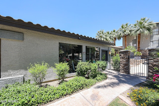 2025 E Campbell Ave Unit 137, Phoenix, AZ 85016 - doorway to property with a gate and stucco siding