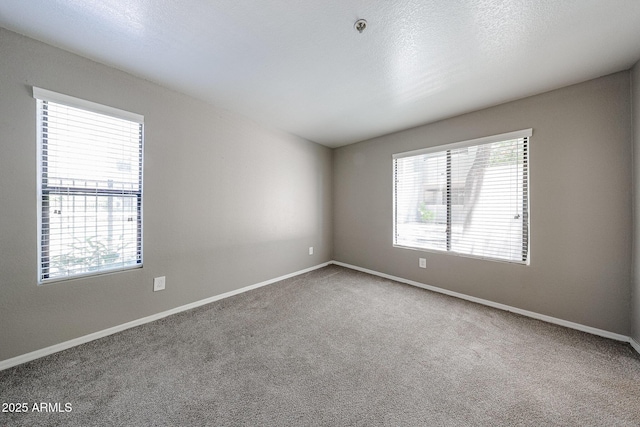 2025 E Campbell Ave Unit 137, Phoenix, AZ 85016 - carpeted spare room with baseboards and fire sprinkler in ceiling