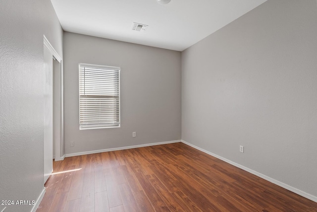 spare room with wood-type flooring