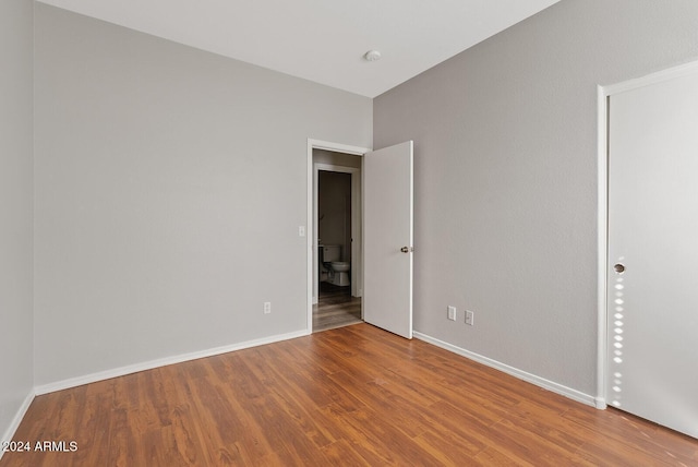 unfurnished room with hardwood / wood-style floors