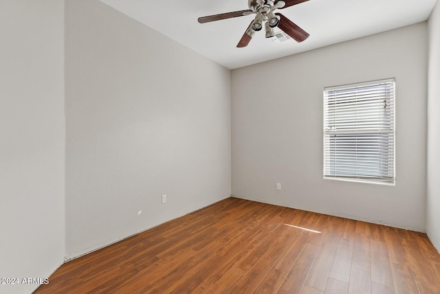 empty room with hardwood / wood-style flooring and ceiling fan