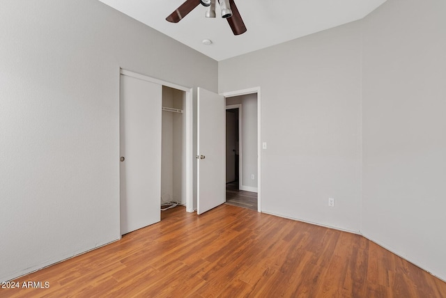 unfurnished bedroom with ceiling fan, hardwood / wood-style floors, and a closet