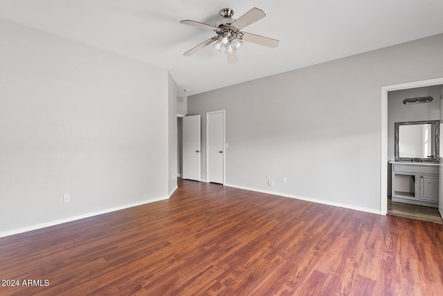 empty room with ceiling fan and dark hardwood / wood-style floors