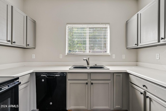 kitchen featuring sink, black appliances, and gray cabinetry