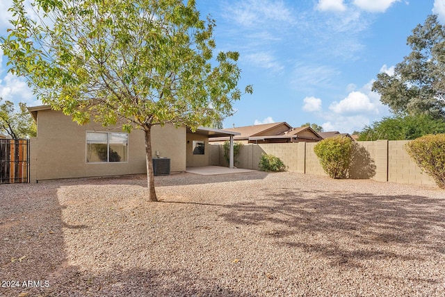 rear view of house featuring cooling unit and a patio