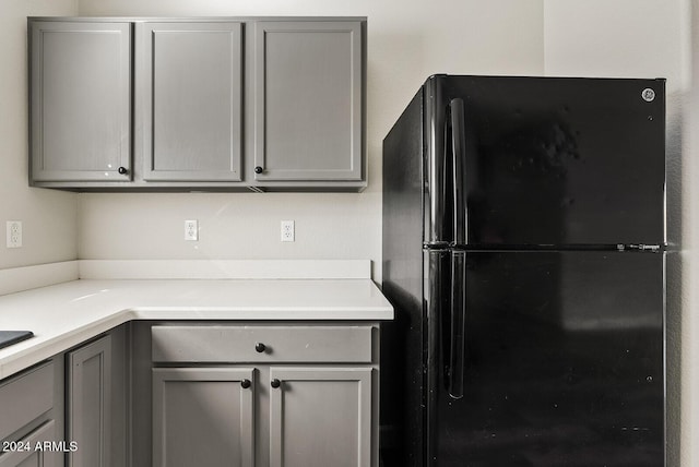 kitchen with black fridge and gray cabinets