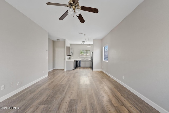 unfurnished living room featuring light hardwood / wood-style floors and ceiling fan