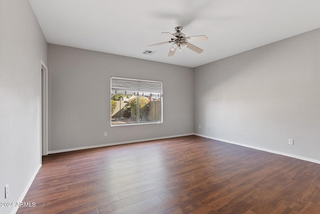 spare room featuring dark hardwood / wood-style floors and ceiling fan