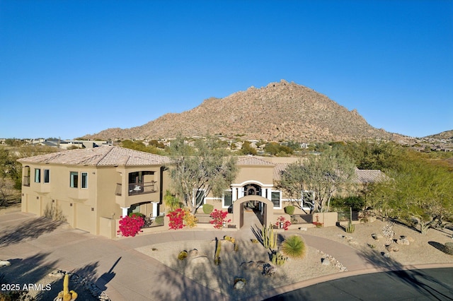 view of front facade featuring a mountain view and a garage