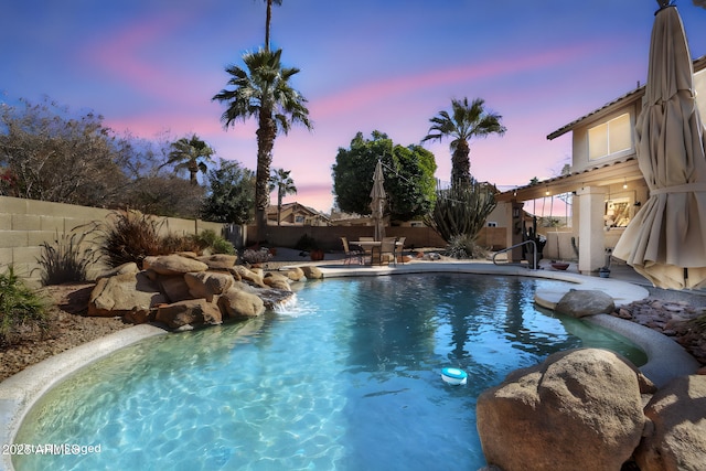 view of pool at dusk