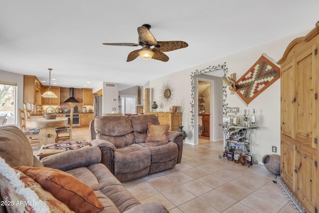 living room featuring light tile patterned flooring and ceiling fan