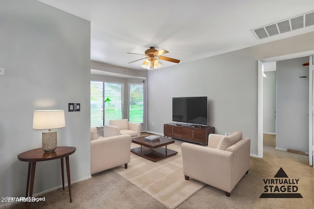 living room with ceiling fan and carpet